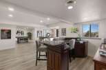 This finished basement offers a fantastic entertainment space, complete with a full bar featuring granite countertops and comfortable bar stools.