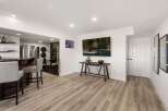 This versatile finished basement offers a complete entertainment and fitness space.