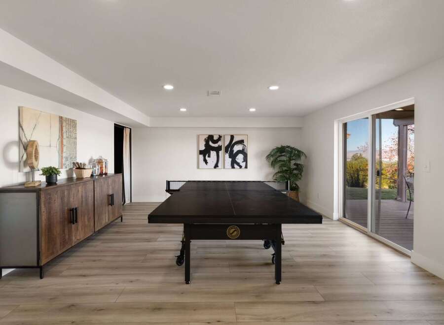 This modern basement offers a perfect blend of recreation and relaxation.