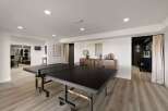 This spacious recreational room features a full-size ping pong table, perfect for friendly competition.