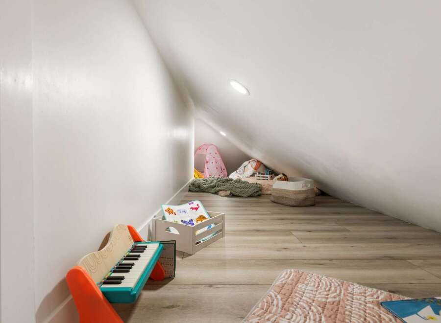 This charming attic space has been transformed into a delightful play area, perfect for children's imagination.