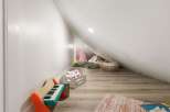 This charming attic space has been transformed into a delightful play area, perfect for children's imagination.