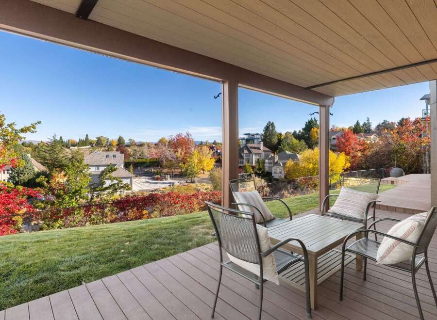 Enjoy breathtaking autumn views from this covered patio, perfect for outdoor dining and relaxation.