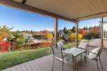 Enjoy breathtaking autumn views from this covered patio, perfect for outdoor dining and relaxation.