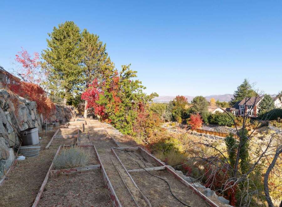 Discover the potential of this expansive property, featuring a tiered garden with raised beds perfect for cultivating your own produce.