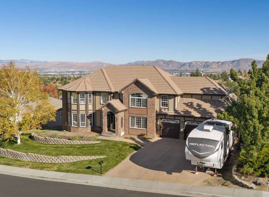 This stunning multi-story brick home offers breathtaking panoramic views of the surrounding mountains and city.