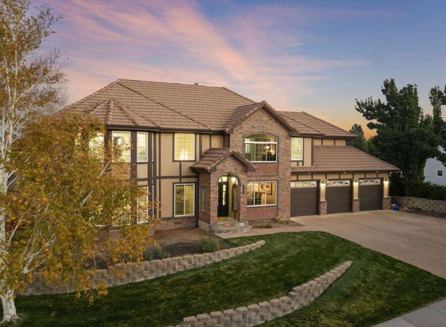 This stunning two-story home boasts a beautiful brick and stucco exterior, complemented by a warm tile roof.