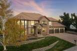 This stunning two-story home boasts a beautiful brick and stucco exterior, complemented by a warm tile roof.