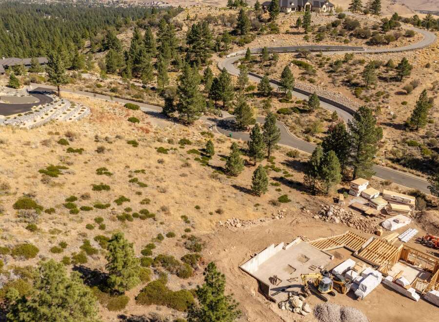 Experience luxury living with this stunning custom home construction nestled in a serene, wooded landscape.