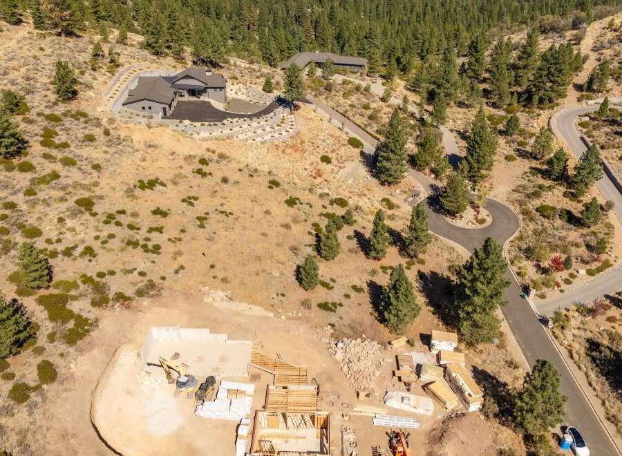 Experience luxury living with this stunning modern home nestled in a serene, wooded landscape.