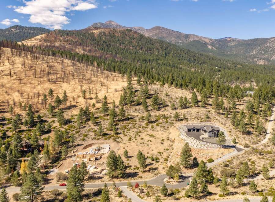 Experience luxury living in this stunning mountain estate, nestled amidst a picturesque landscape of pine trees and rolling hills.
