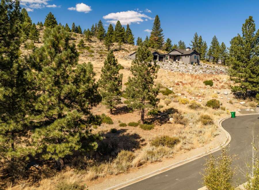 Nestled on a picturesque hillside, this modern home offers stunning views and a serene natural setting.