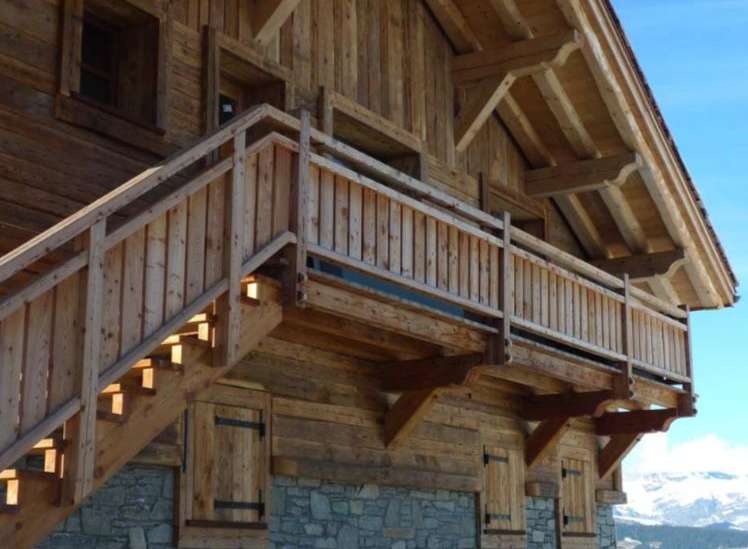 This stunning chalet boasts a beautiful wooden exterior with exposed beams and stonework.