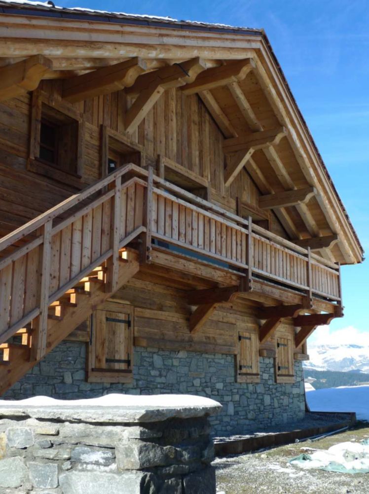 This stunning chalet boasts a beautiful wooden exterior with exposed beams and stonework.
