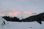 Snowy mountain peak at sunset.