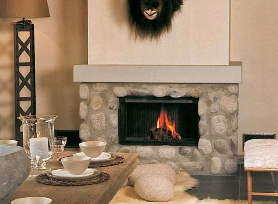 Cozy mountain chalet with a stone fireplace, creating a warm and inviting atmosphere.