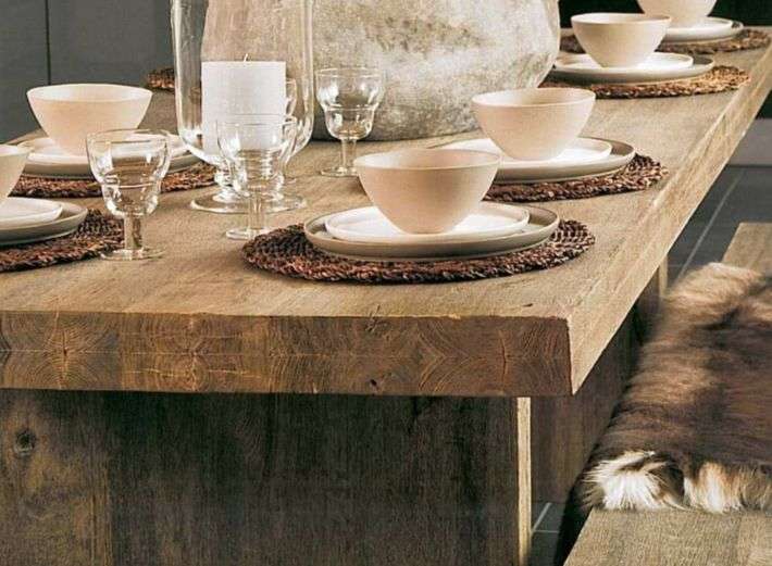 Rustic wooden dining table with built-in bench seating, perfect for enjoying meals with family and friends.