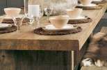 Rustic wooden dining table with built-in bench seating, perfect for enjoying meals with family and friends.