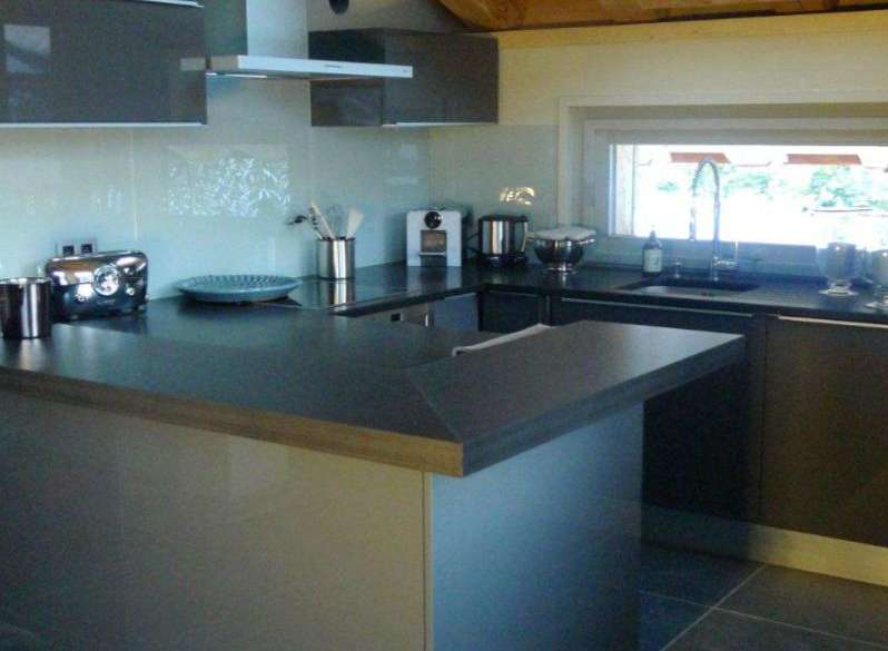 This stunning kitchen boasts a modern design with sleek gray cabinetry and a spacious island.
