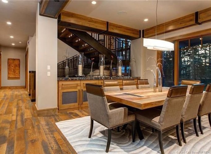 This stunning home boasts a spacious dining area with a rustic-chic design, perfect for entertaining guests.