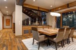 This stunning home boasts a spacious dining area with a rustic-chic design, perfect for entertaining guests.