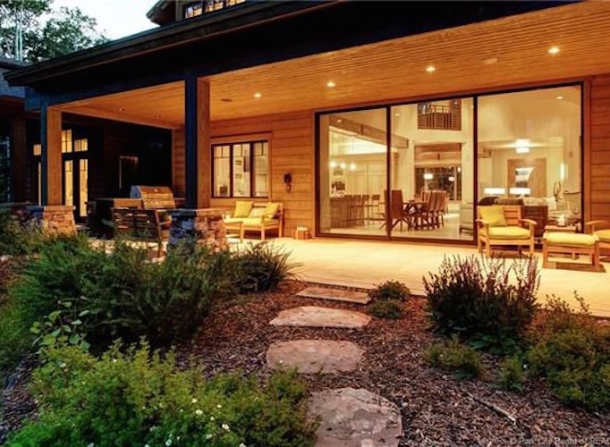 This stunning property boasts a spacious covered patio, perfect for outdoor entertaining, with a built-in grill and comfortable seating.