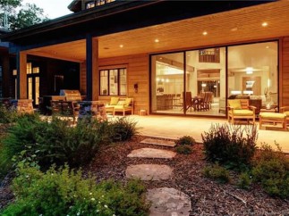 This stunning property boasts a spacious covered patio, perfect for outdoor entertaining, with a built-in grill and comfortable seating.