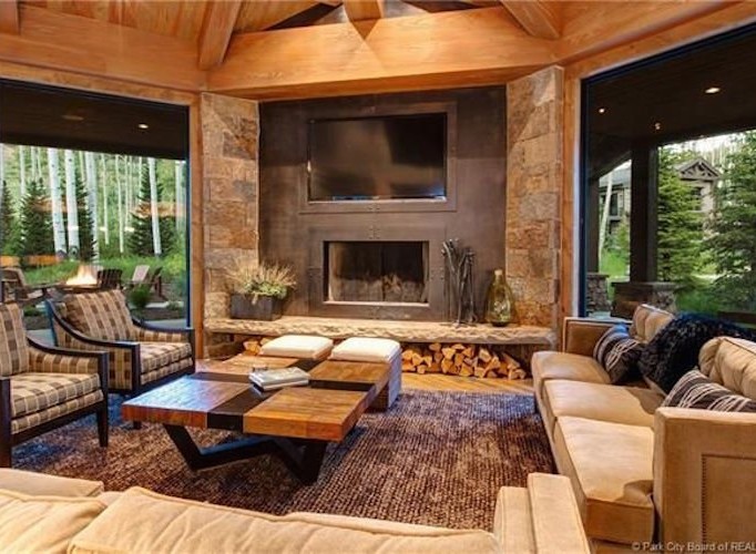 This stunning mountain home boasts a spacious open floor plan with floor-to-ceiling windows showcasing breathtaking views.