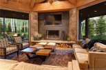 This stunning mountain home boasts a spacious open floor plan with floor-to-ceiling windows showcasing breathtaking views.