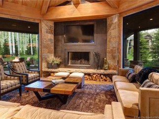 This stunning mountain home boasts a spacious open floor plan with floor-to-ceiling windows showcasing breathtaking views.