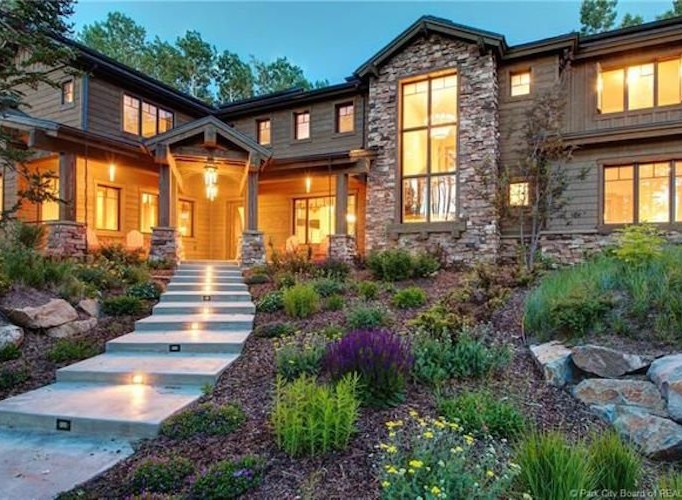 Luxury mountain home with stunning stone and wood exterior.