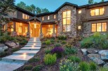 Luxury mountain home with stunning stone and wood exterior.