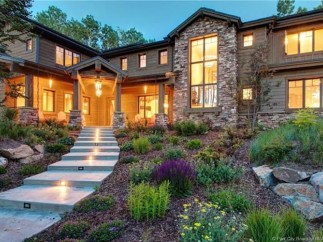 Luxury mountain home with stunning stone and wood exterior.