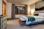 This stunning bedroom boasts a cozy and elegant atmosphere, featuring large windows that offer breathtaking views and allow ample natural light to flood the space.