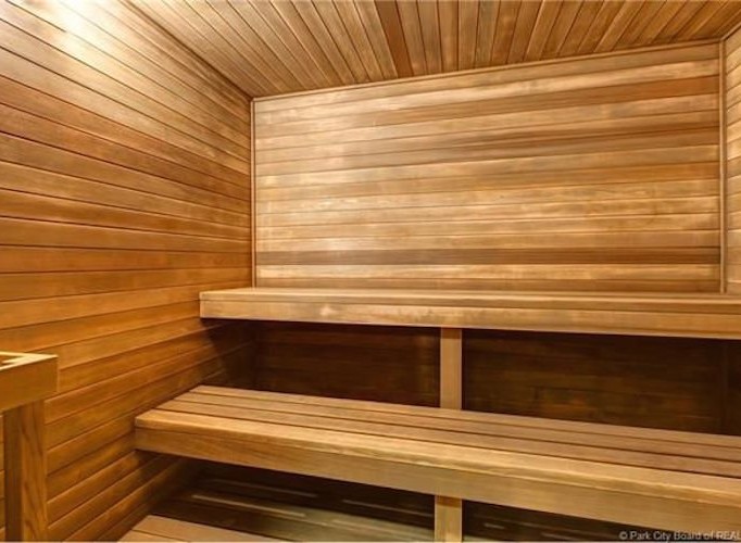 Relax and rejuvenate in this luxurious sauna, featuring rich wood paneling and spacious seating.