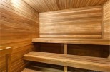 Relax and rejuvenate in this luxurious sauna, featuring rich wood paneling and spacious seating.
