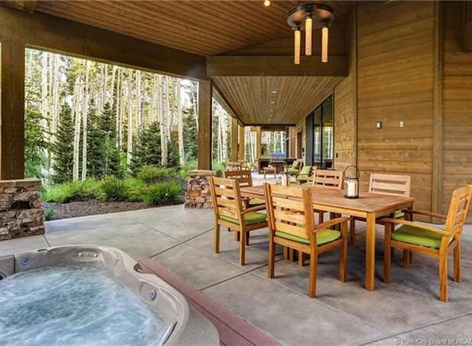 This stunning property boasts a spacious outdoor patio with a hot tub, perfect for relaxation and entertaining.