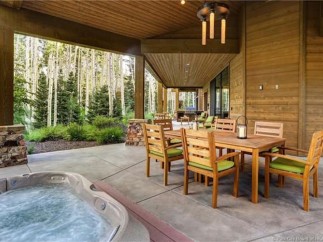 This stunning property boasts a spacious outdoor patio with a hot tub, perfect for relaxation and entertaining.