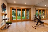 This stunning home boasts a private gym, complete with state-of-the-art equipment and large windows offering scenic views.