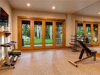 This stunning home boasts a private gym, complete with state-of-the-art equipment and large windows offering scenic views.