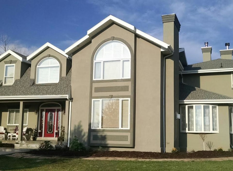 This stunning two-story home boasts a large front porch, arched windows, and a spacious backyard.