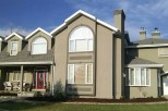 This stunning two-story home boasts a large front porch, arched windows, and a spacious backyard.