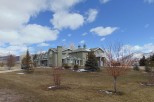 This stunning property boasts a large, custom-built home with expansive windows offering breathtaking mountain views.