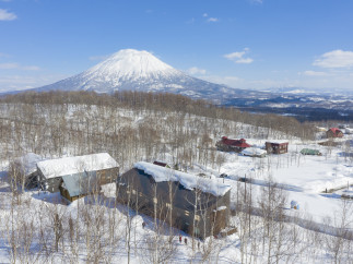 Nestled in a snowy landscape, this stunning property offers breathtaking views of a snow-capped volcano.