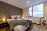 Cozy bedroom with a king-size bed, plush bedding, and a large window offering stunning views.