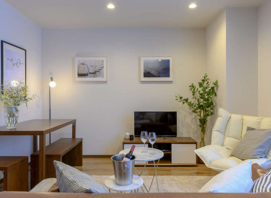 Modern living room with comfortable seating, stylish decor, and a convenient dining area.