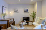 Modern living room with comfortable seating, stylish decor, and a convenient dining area.