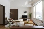 Relax in this stylish living room, featuring floor-to-ceiling windows offering stunning views and ample natural light.
