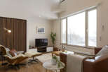 Modern living room with floor-to-ceiling windows offering stunning views.