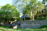 This charming stone house is nestled amongst lush greenery, offering a tranquil and picturesque setting.